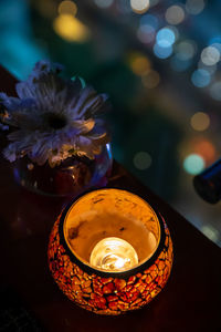 Close-up of illuminated flower pot on table