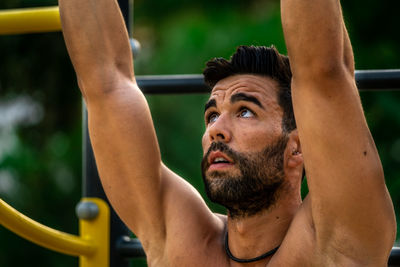 Close-up of young man wearing exercising outdoors