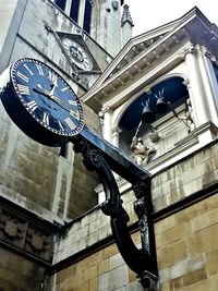 Low angle view of clock against building