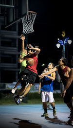 Man jumping on basketball hoop