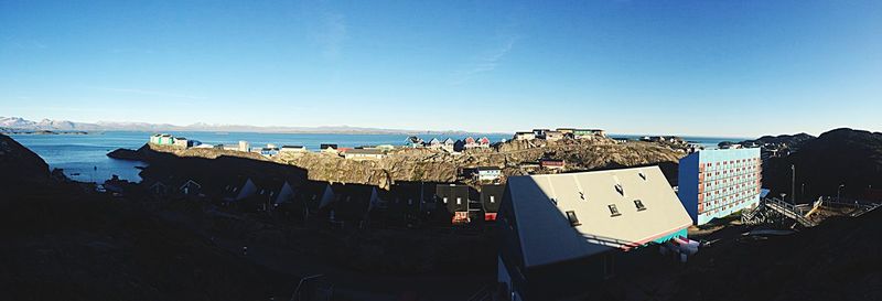 Panoramic view of beach against clear blue sky