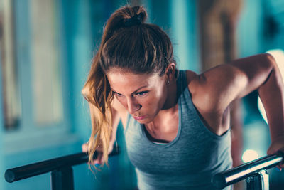 Mid adult woman exercising on parallel bar