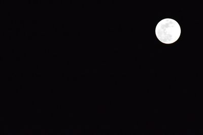 Low angle view of moon against sky at night