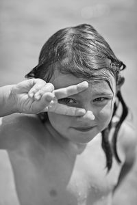 Portrait of girl showing peace sign