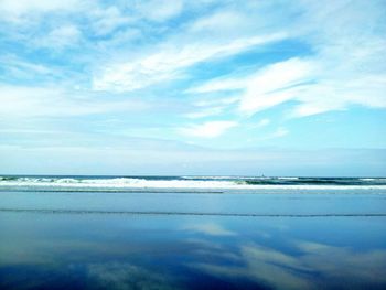 Scenic view of sea against cloudy sky