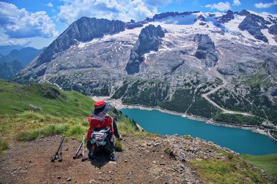 Senior woman sitting on mountain peak with beautiful view in background