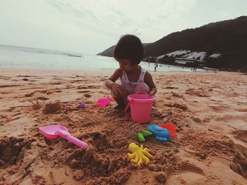 Girl with toy on beach