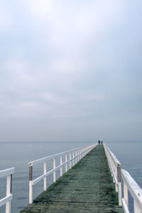 Pier amidst sea against sky