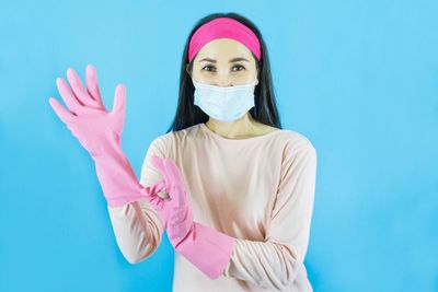 Portrait of woman against blue background