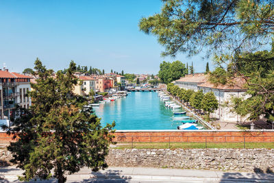 View of swimming pool by buildings against sky