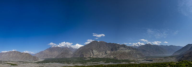 Scenic view of mountains against blue sky