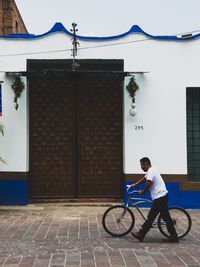 Man riding bicycle on building