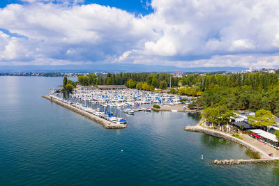 High angle view of marina and sea against sky