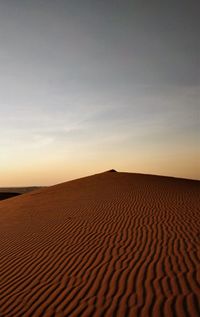 Scenic view of desert against sky during sunset