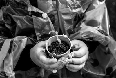 Midsection of child holding sapling