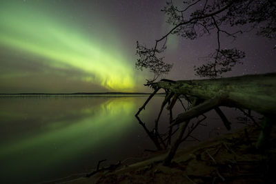 Scenic view of lake against sky at night