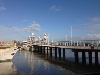 View of bridge over river against blue sky