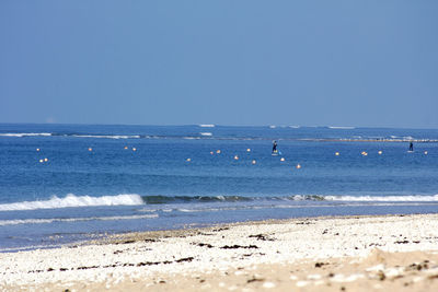 Scenic view of sea against clear blue sky