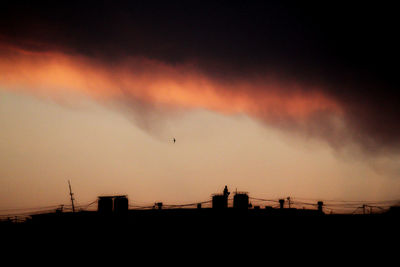 Low angle view of silhouette buildings against sky during sunset