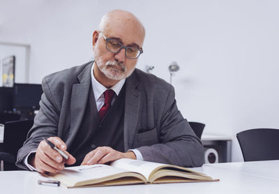 Portrait of man sitting on table