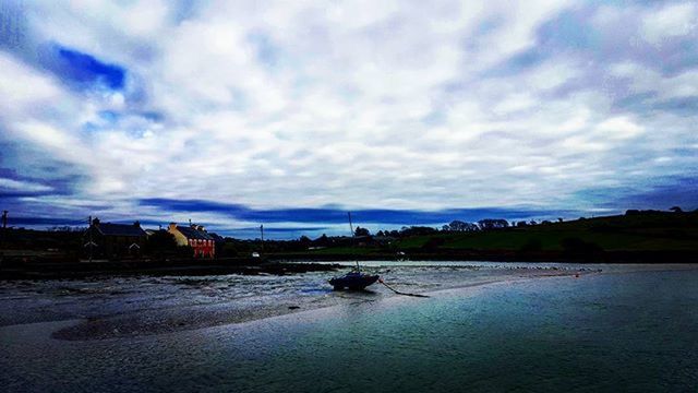 water, sky, cloud - sky, built structure, architecture, cloudy, building exterior, waterfront, river, cloud, lake, transportation, weather, nature, nautical vessel, tranquility, reflection, tranquil scene, overcast, scenics