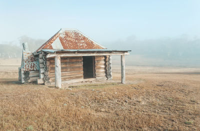 Built structure on field against sky