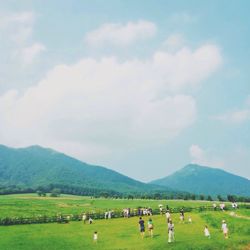 Scenic view of grassy field against cloudy sky