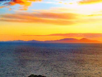 Scenic view of sea against romantic sky at sunset
