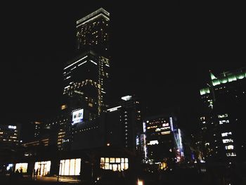 Low angle view of illuminated buildings at night