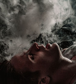 Close-up portrait of young woman smoking