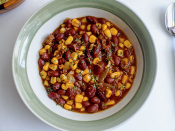 High angle view of beans and corns in bowl on table