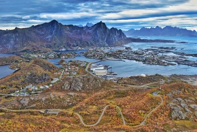 Scenic view of sea and mountains against sky