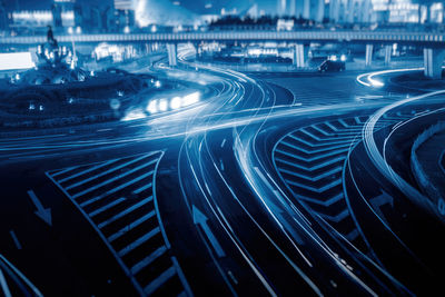 High angle view of light trails on road in city at night