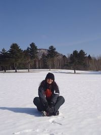 Full length of woman on snow covered field during winter