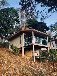 Low angle view of building and trees against sky