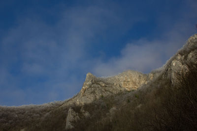 Low angle view of rock formation against sky