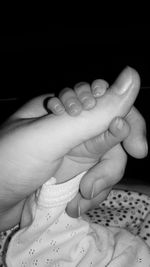 Close-up of baby hand holding candles