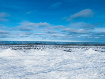 Scenic view of sea against blue sky