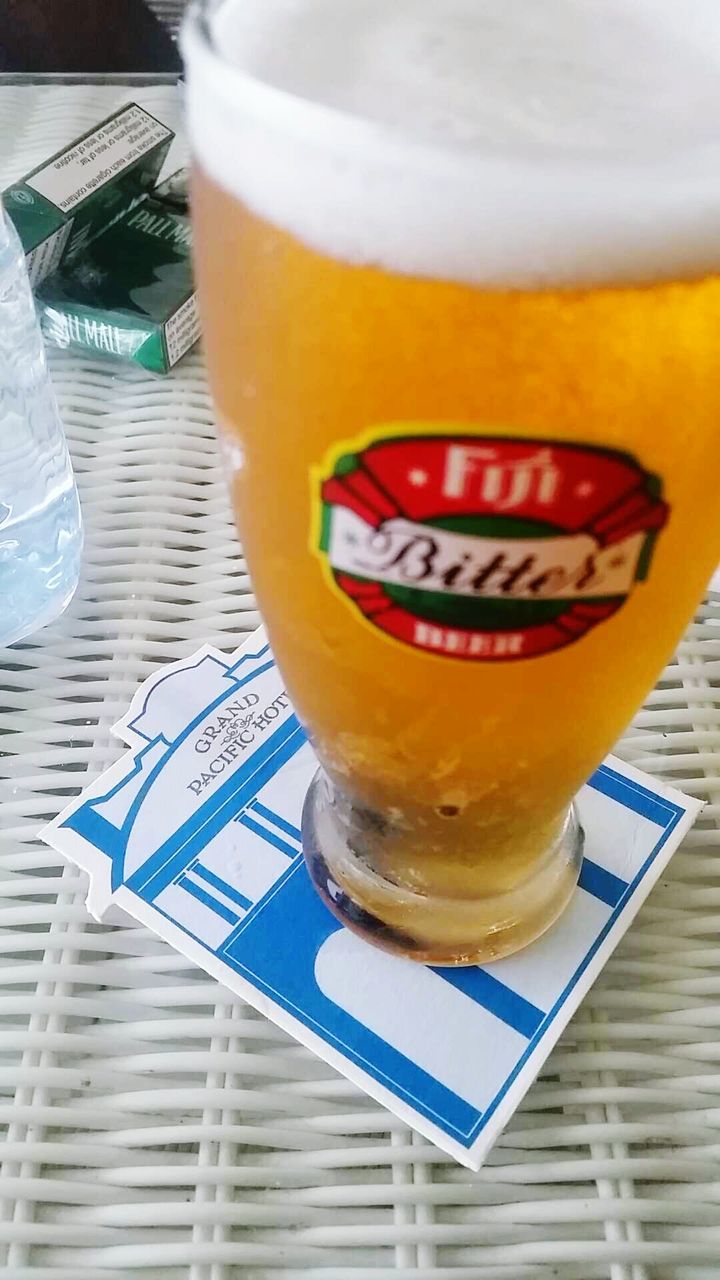 food and drink, drink, refreshment, freshness, table, indoors, text, still life, drinking glass, close-up, western script, communication, frothy drink, alcohol, glass - material, coffee cup, beer - alcohol, drinking straw, sweet food, focus on foreground