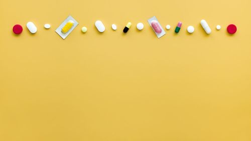 High angle view of multi colored pencils against yellow background