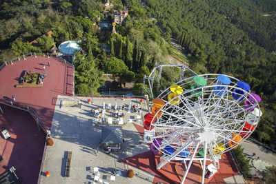 High angle view of ferris wheel against trees
