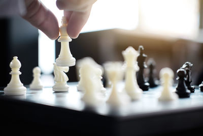 Cropped hand playing chess