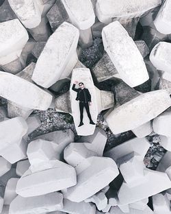 Directly above shot of man lying on tetrapod