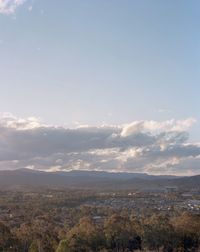 Scenic view of mountains against cloudy sky