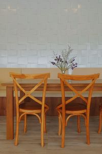 Empty chairs and table against wall at home