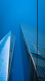 Low angle view of modern building against clear blue sky