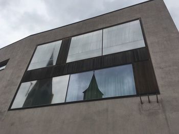 Low angle view of building against cloudy sky