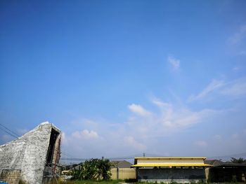 Low angle view of building against cloudy sky