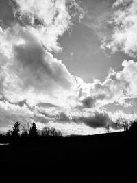 Low angle view of silhouette trees on field against sky