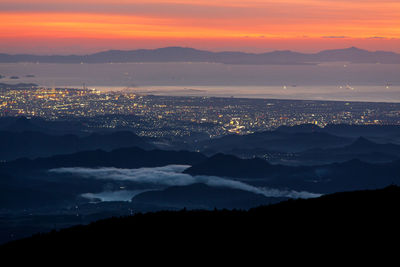 Aerial view of city lit up at night